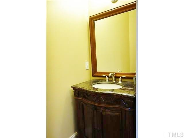11320 Honeycutt Road, Unit LOT12 Raleigh, NC 27614 - Photo 10 of 25 A 1st floor powder room is convenient for guests with a gorgeous, decorative vanity & hardwood floors. Powder room
