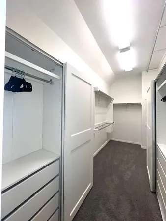 an empty room with a ceiling fan and a window