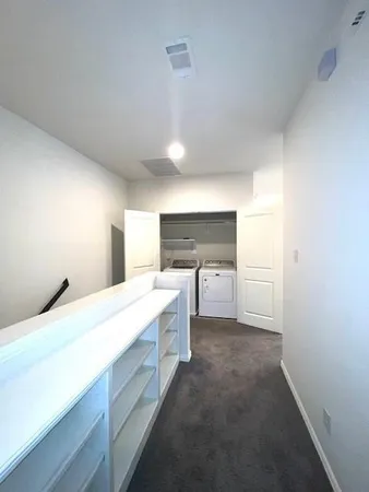 an empty room with a empty space and windows