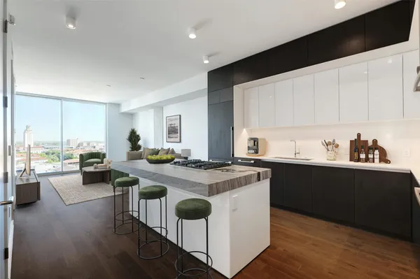 a open kitchen with stainless steel appliances granite countertop a stove and a refrigerator