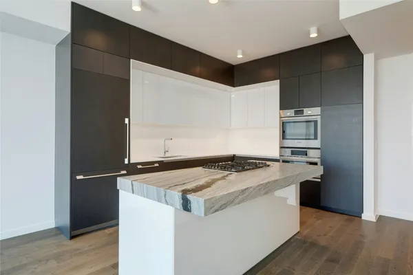 a kitchen that has a sink and a stove in it