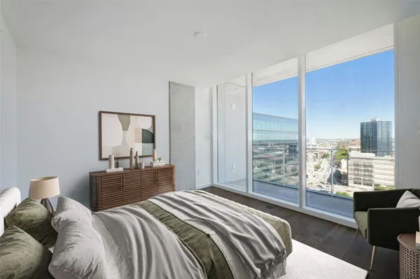 a bedroom with a large bed and a lamp