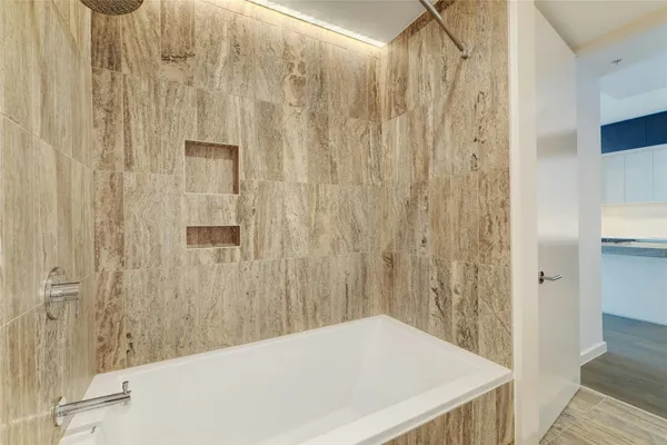 a bathroom with a bathtub and shower