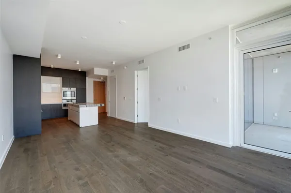a view of a kitchen with a sink and a refrigerator