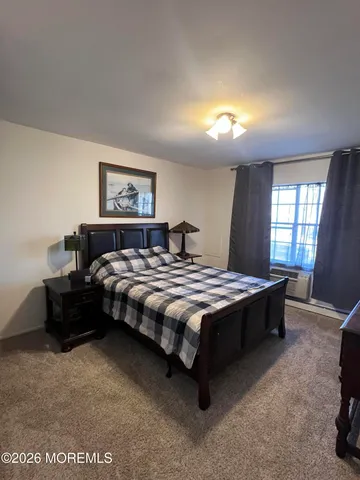 a spacious bedroom with a bed and a window