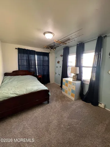 a bedroom with a bed closet and mirror