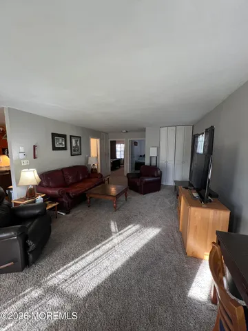 a bedroom with furniture and a flat screen tv