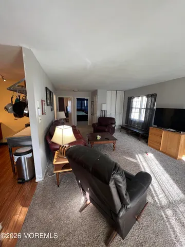 a living room with furniture and a lamp