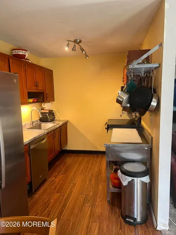 a kitchen with a wooden floor and a sink