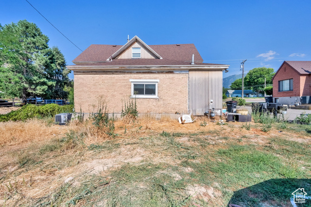 1632 South Main Street Springville, UT 84663 - Photo 76 of 93 View of home's exterior featuring brick siding and a central air condition unit