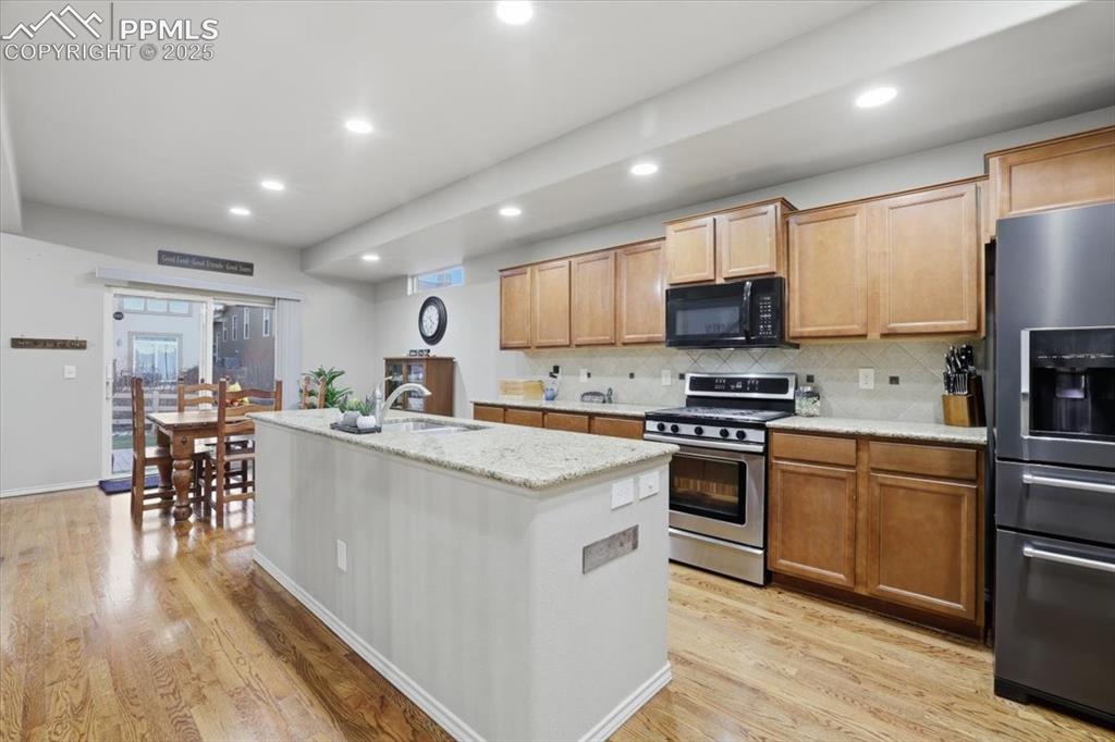 2374 Cinnabar Road Colorado Springs, CO 80921 - Photo 21 of 47 The kitchen has lots of can lights and natural lighting from the sliding glass doors.