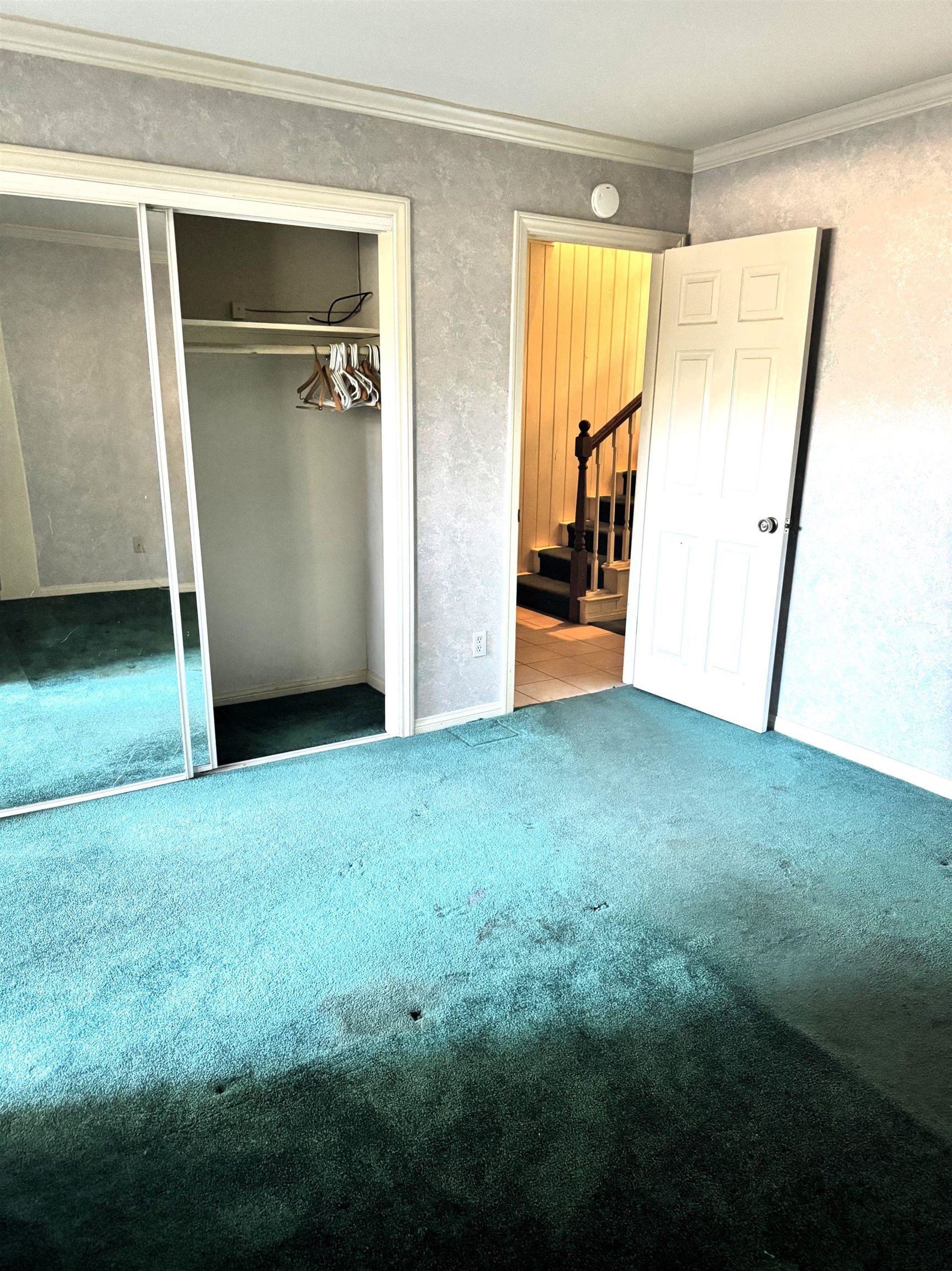 4 Kelley Road, Unit 1 Mammoth Lakes, CA 93546 - Photo 6 of 19 Spacious room featuring patterned wallpaper, crown molding, and a wide entryway