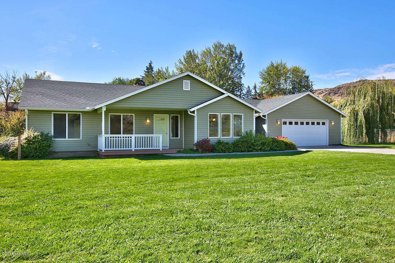 9645 South Naches Road Naches, WA 98937 - Photo 1 of 18 a front view of a house with a garden