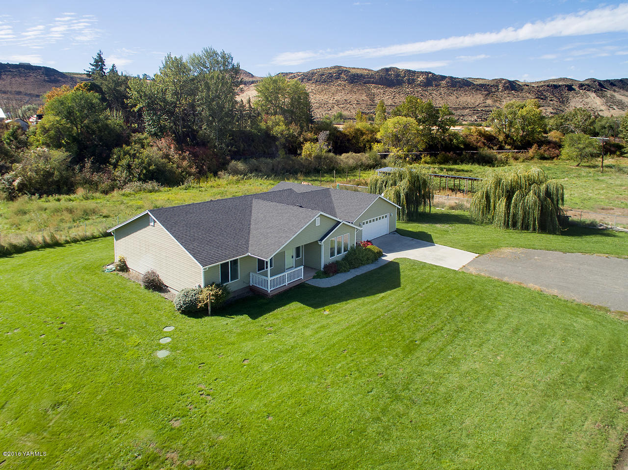 9645 South Naches Road Naches, WA 98937 - Photo 2 of 18 an aerial view of a house with yard and green space