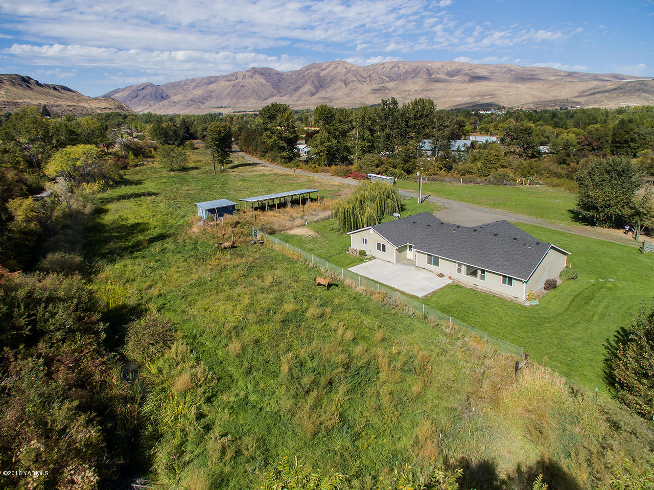 9645 South Naches Road Naches, WA 98937 - Photo 15 of 18 aerial view of a house with a yard