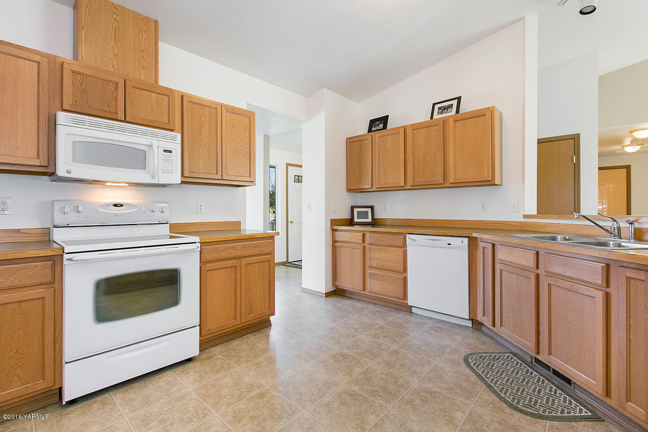 9645 South Naches Road Naches, WA 98937 - Photo 5 of 18 a kitchen with granite countertop a sink stainless steel appliances and cabinets