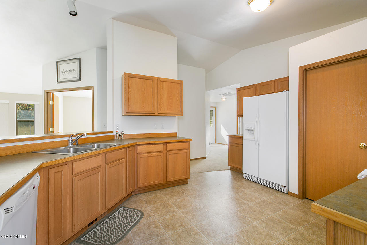 9645 South Naches Road Naches, WA 98937 - Photo 6 of 18 a large kitchen with a sink and refrigerator