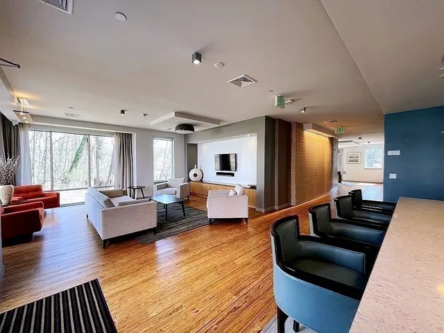 a living room with furniture fireplace and wooden floor