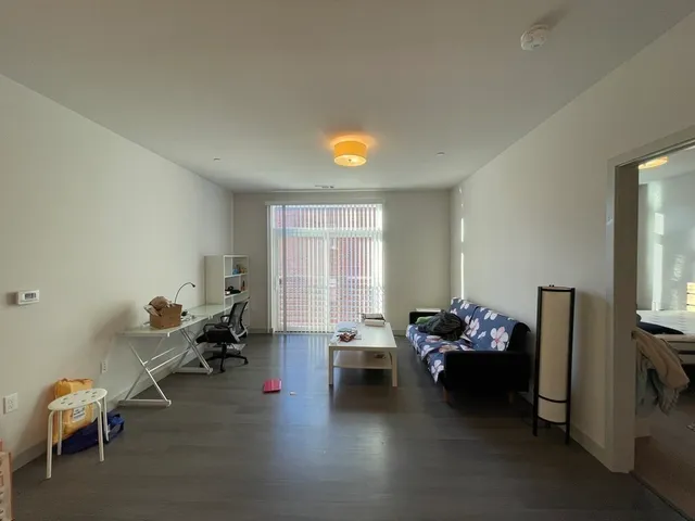 a living room with furniture chess board and a window