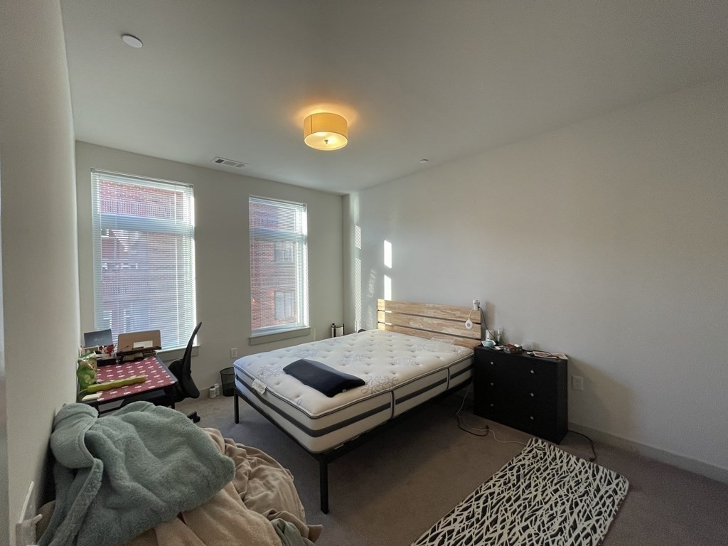 99 Tremont Street, Unit 313 Boston, MA 02135 - Photo 6 of 13 a bedroom with bed and window