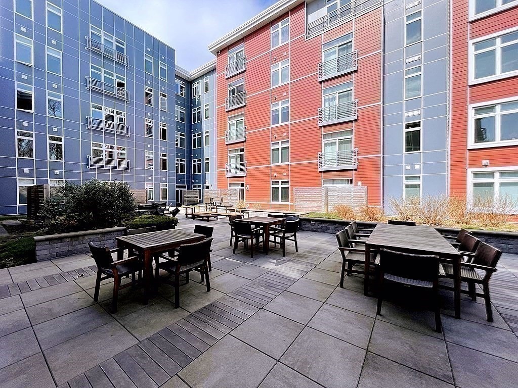 99 Tremont Street, Unit 313 Boston, MA 02135 - Photo 10 of 13 a view of a dinning table and chairs in the patio