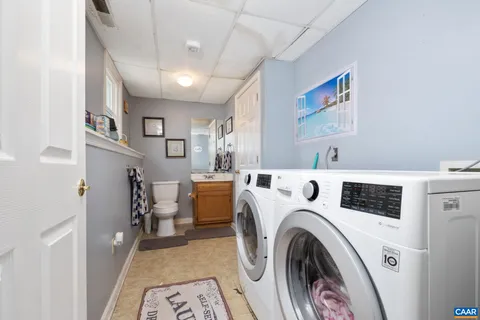 a view of a storage & utility room with dryer and washer