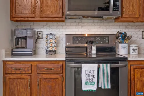 a kitchen with granite countertop stainless steel appliances stove and cabinets