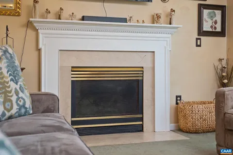 a living room with a fireplace and a rug