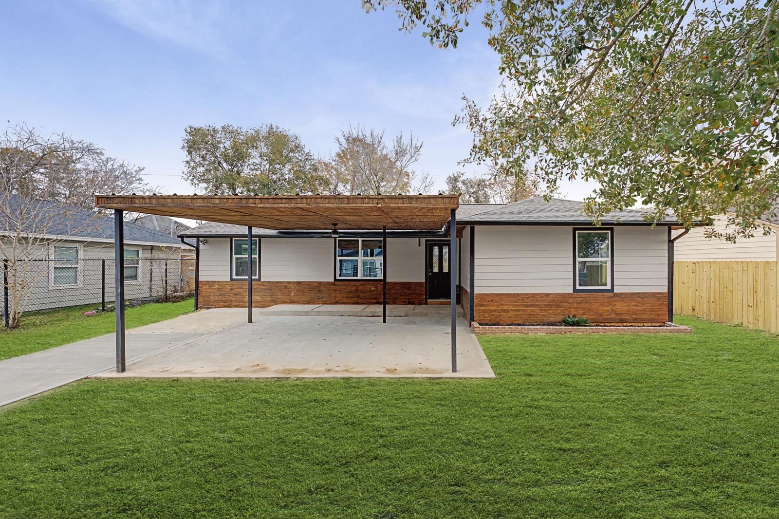 5719 Southwind Street Houston, TX 77033 - Photo 3 of 15 a view of a house with a backyard and a tree