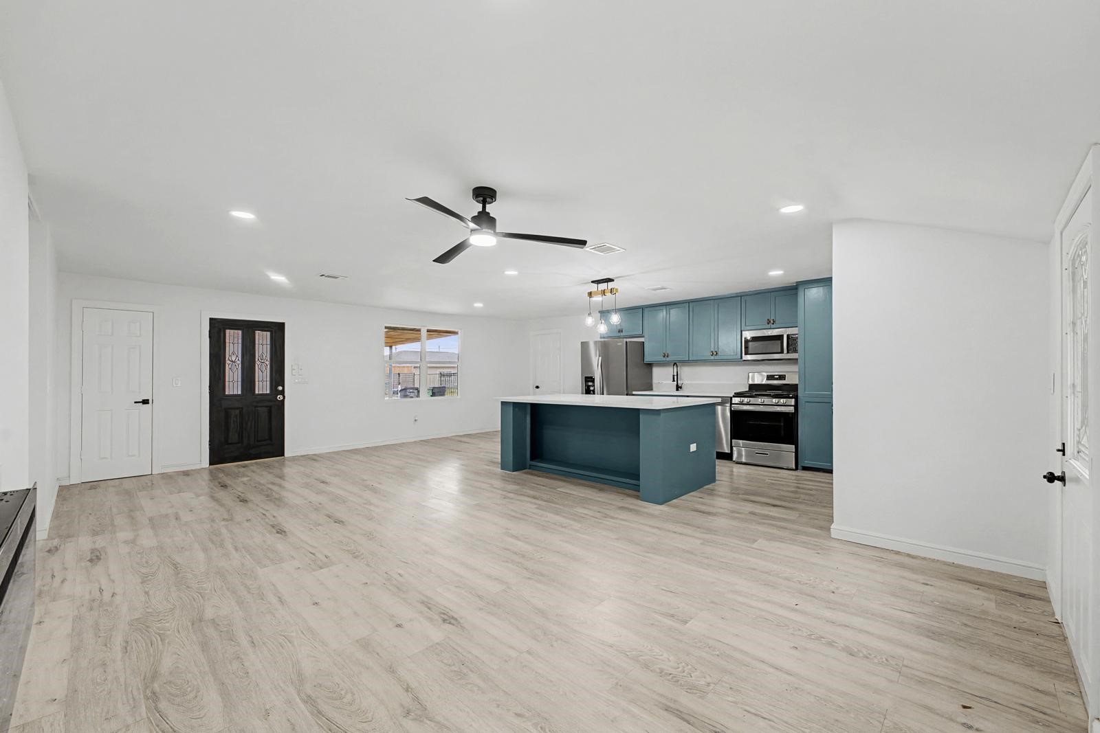 5719 Southwind Street Houston, TX 77033 - Photo 8 of 15 a view of kitchen with wooden floor