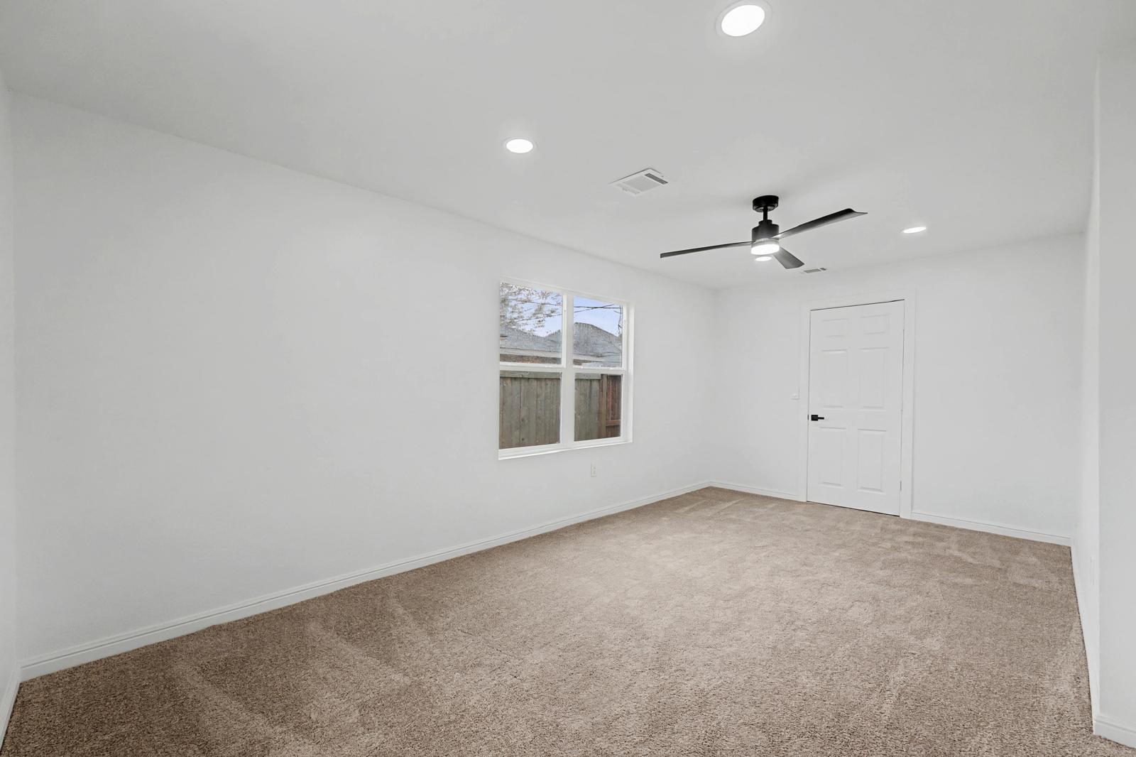 5719 Southwind Street Houston, TX 77033 - Photo 9 of 15 a view of an empty room with a window