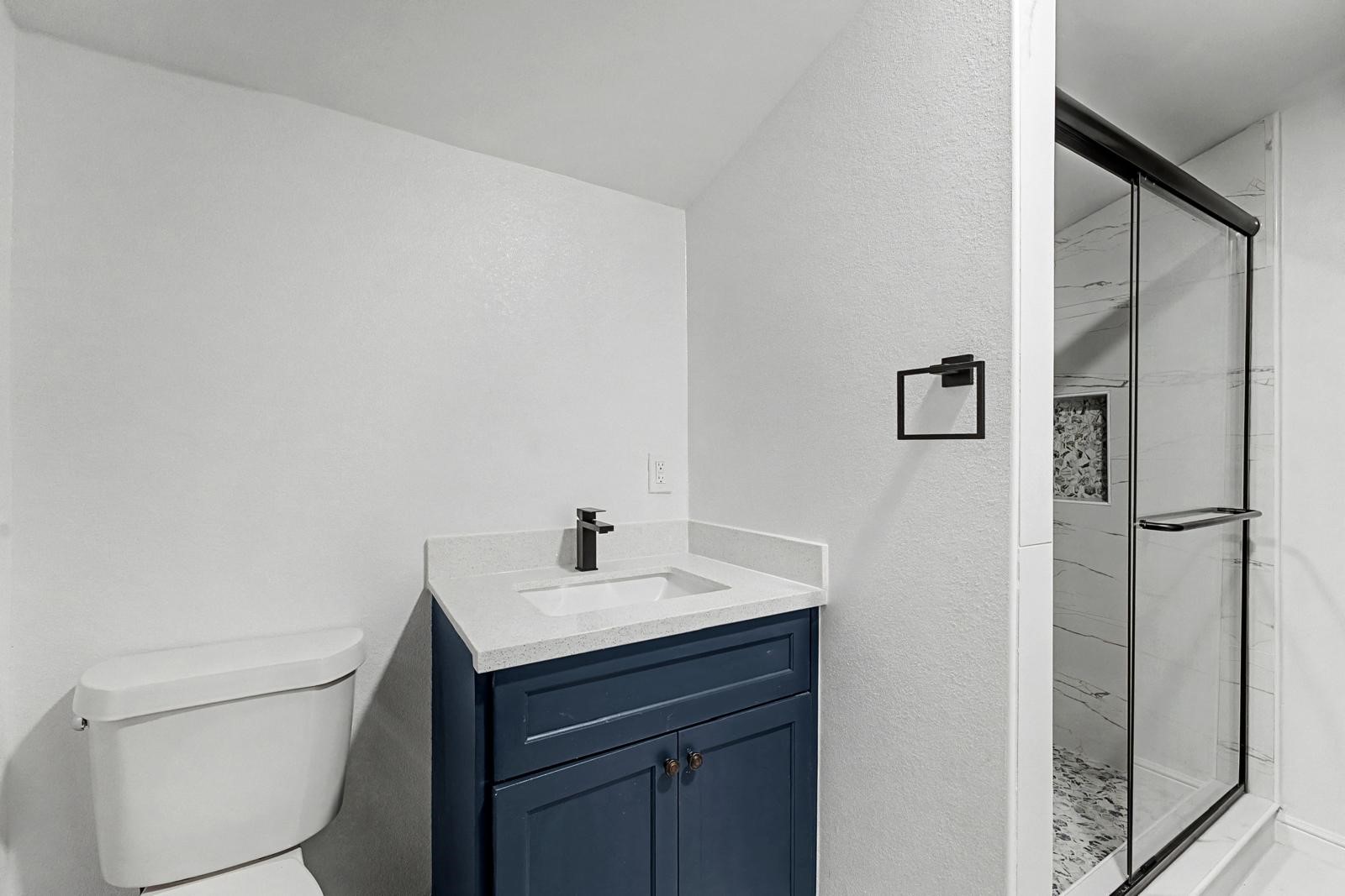 5719 Southwind Street Houston, TX 77033 - Photo 10 of 15 a bathroom with a sink toilet and vanity