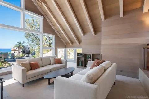 a living room with furniture and a floor to ceiling window