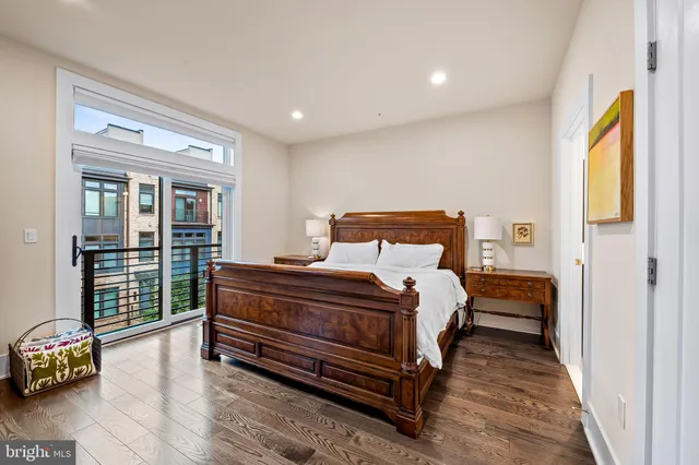 a bedroom with a large bed and a flat screen tv