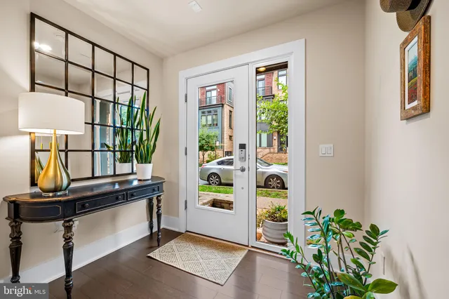 a view of a hallway with wooden floor and staircase