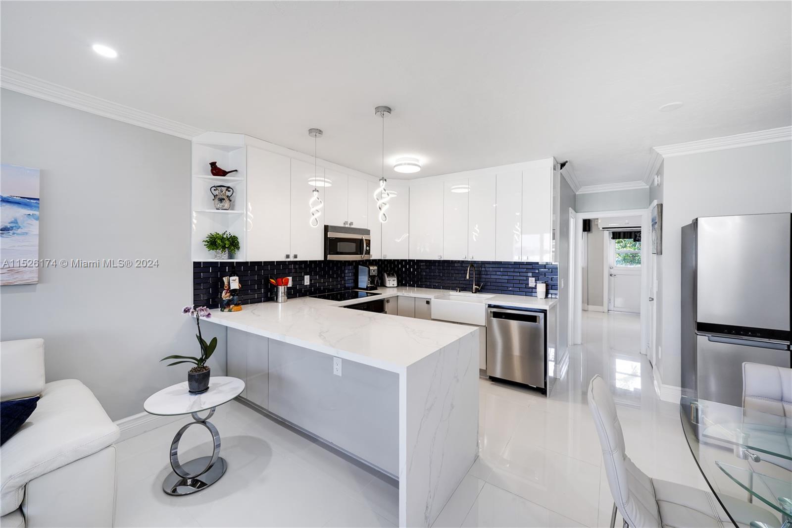 a kitchen with stainless steel appliances kitchen island a refrigerator and a counter top space
