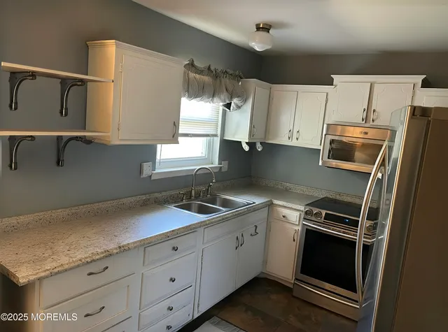 a kitchen with a sink and a refrigerator