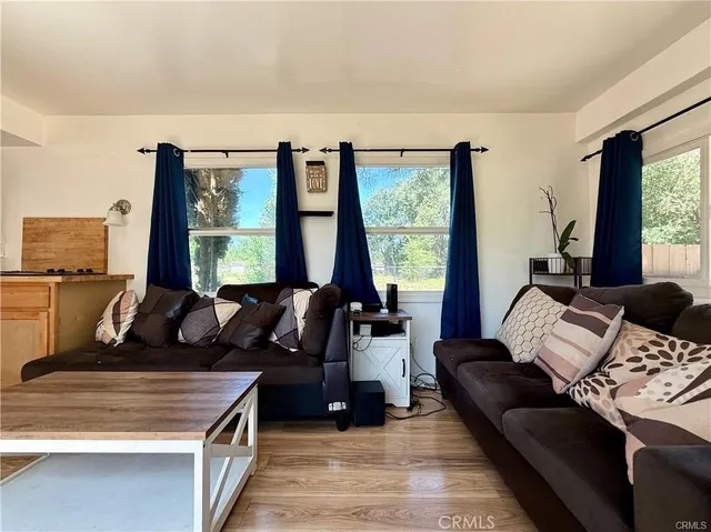 a living room with furniture and large windows