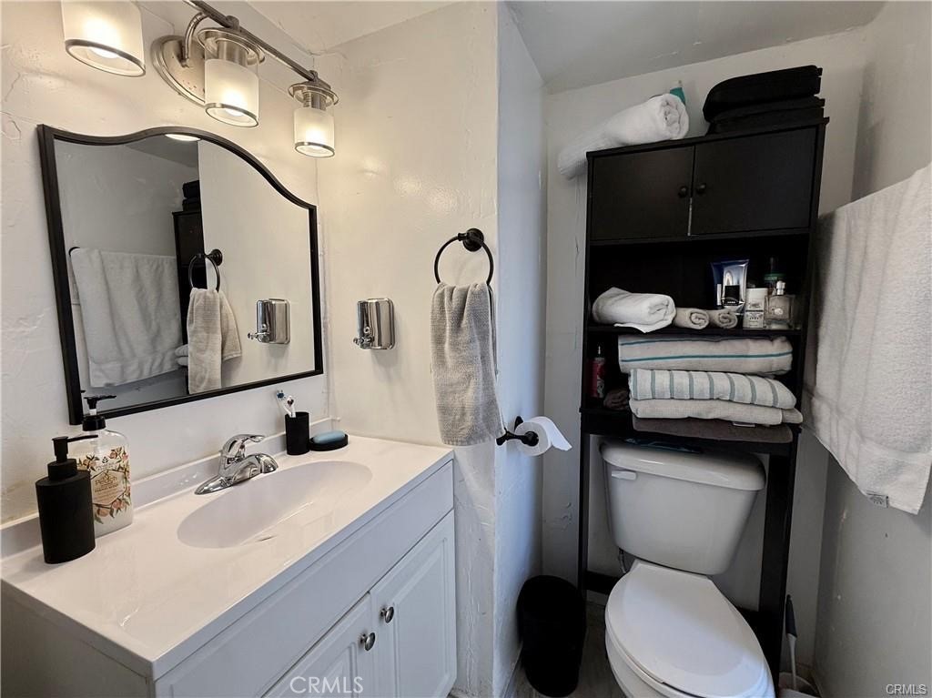 7665 Cache Creek Way Clearlake, CA 95422 - Photo 17 of 41 a bathroom with a toilet sink and mirror