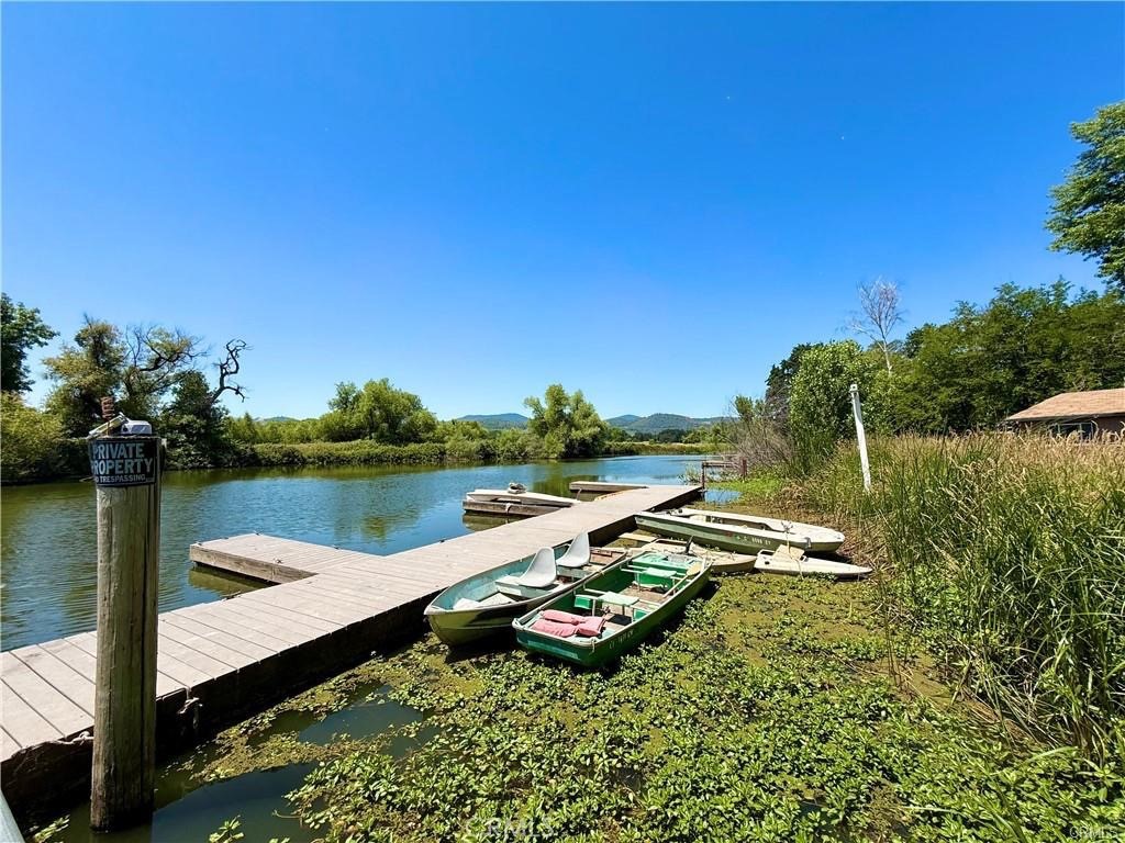 7665 Cache Creek Way Clearlake, CA 95422 - Photo 24 of 41 a view of a lake with lawn chairs