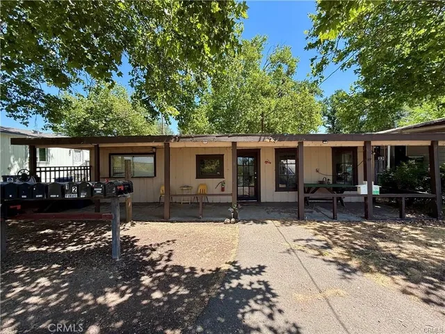 a front view of house with a bench in patio