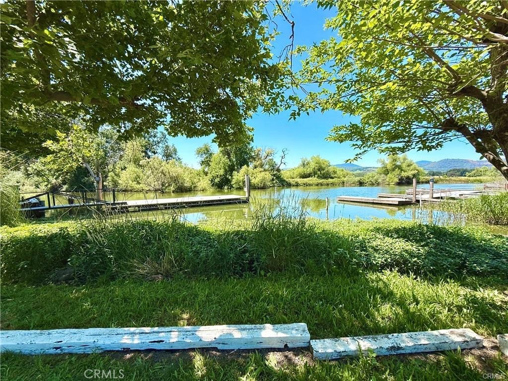 7665 Cache Creek Way Clearlake, CA 95422 - Photo 33 of 41 a view of a lake with a big yard