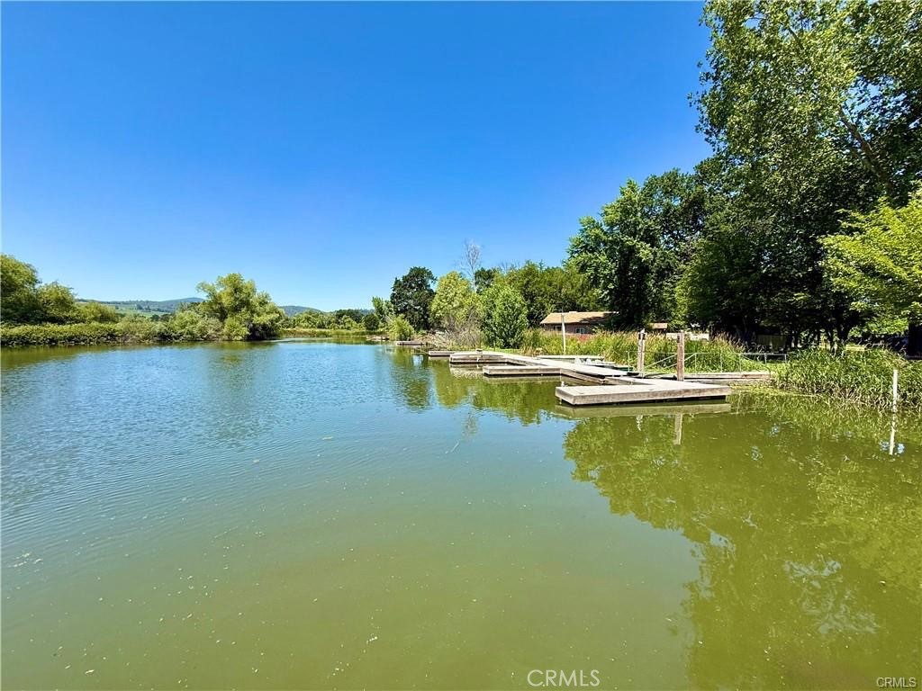 7665 Cache Creek Way Clearlake, CA 95422 - Photo 35 of 41 a view of a lake with houses in the background