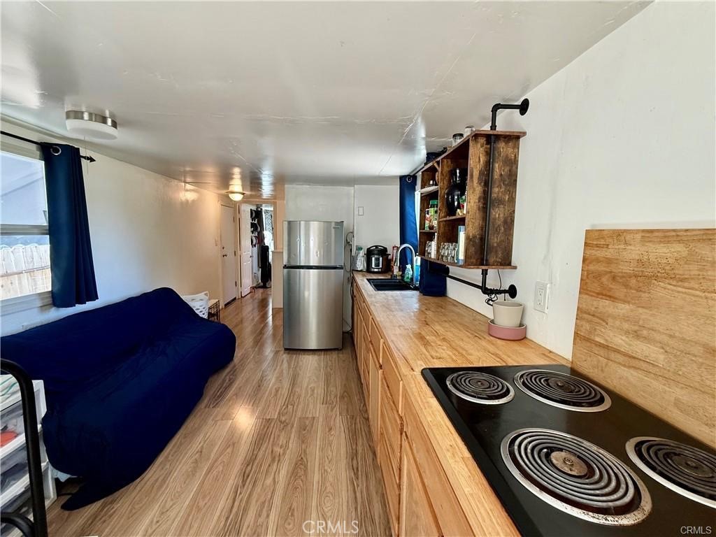 7665 Cache Creek Way Clearlake, CA 95422 - Photo 9 of 41 a kitchen with a stove and a refrigerator