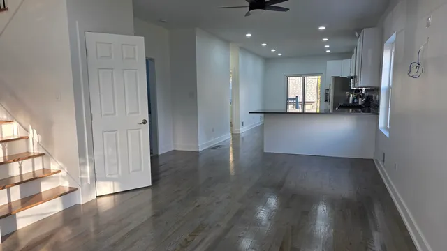 a kitchen with granite countertop a refrigerator stove top oven and sink