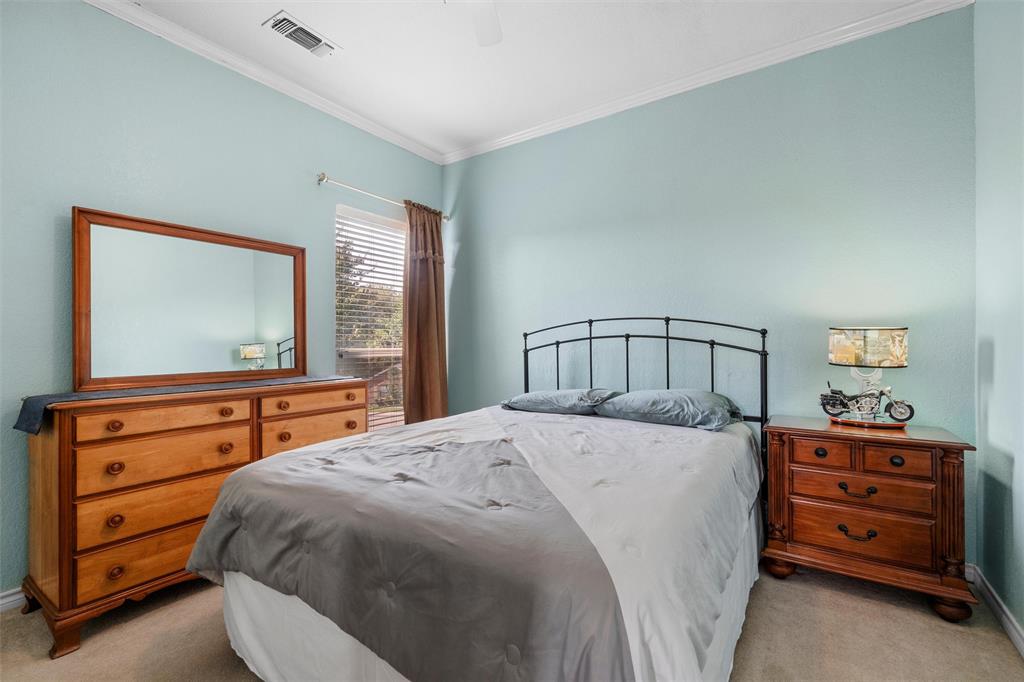 2114 Trace Ridge Drive Weatherford, TX 76087 - Photo 12 of 14 a bedroom with a bed and a dresser