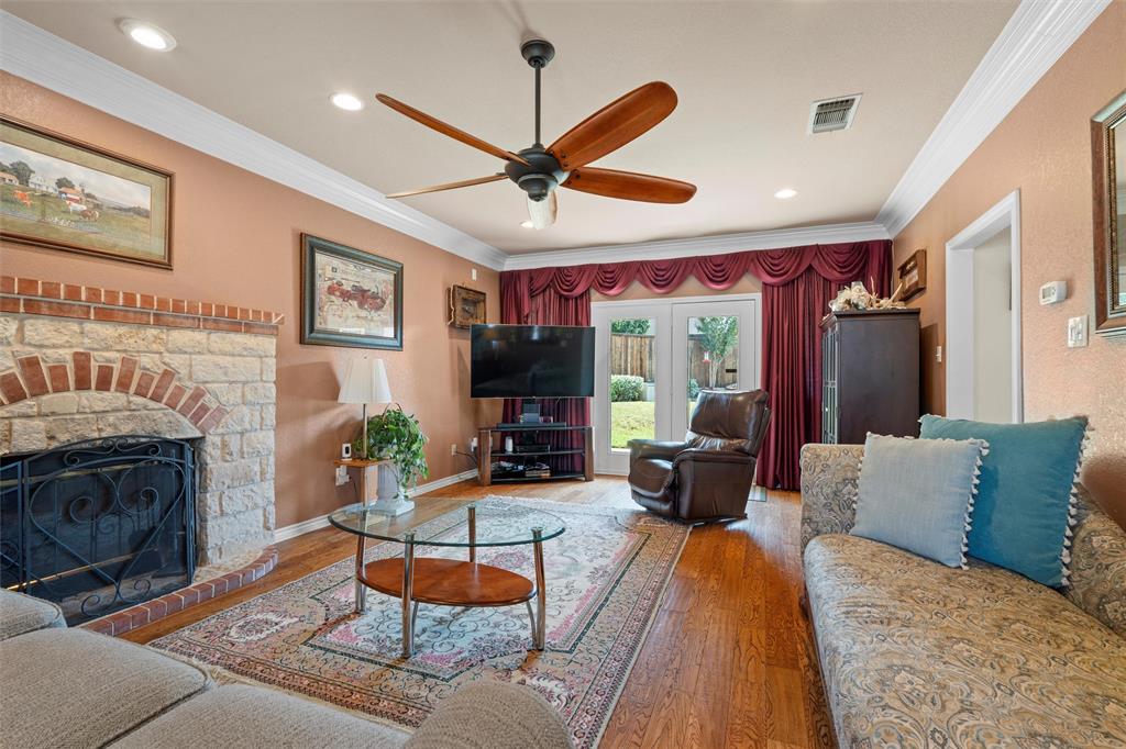 2114 Trace Ridge Drive Weatherford, TX 76087 - Photo 2 of 14 a living room with furniture a fireplace and a ceiling fan