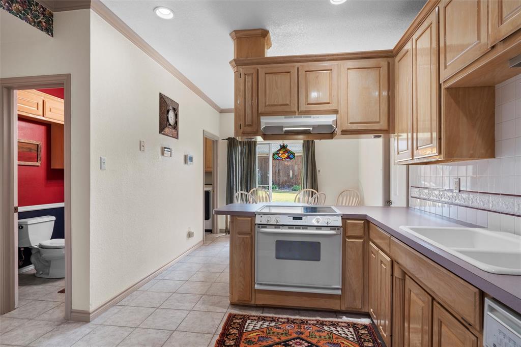 2114 Trace Ridge Drive Weatherford, TX 76087 - Photo 6 of 14 a kitchen with stainless steel appliances a stove and a sink