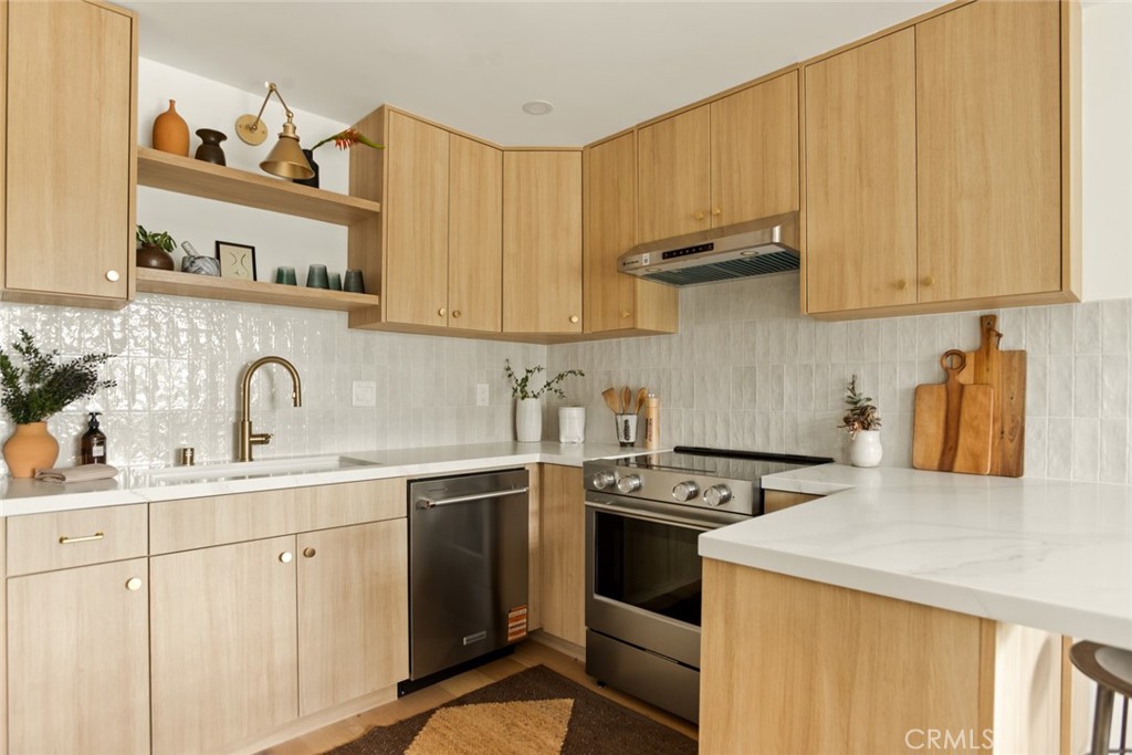 334 Gladys Avenue, Unit 305 Long Beach, CA 90814 - Photo 8 of 26 a kitchen with stainless steel appliances granite countertop a sink stove and cabinets