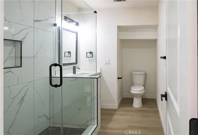 a bathroom with a shower sink and mirror